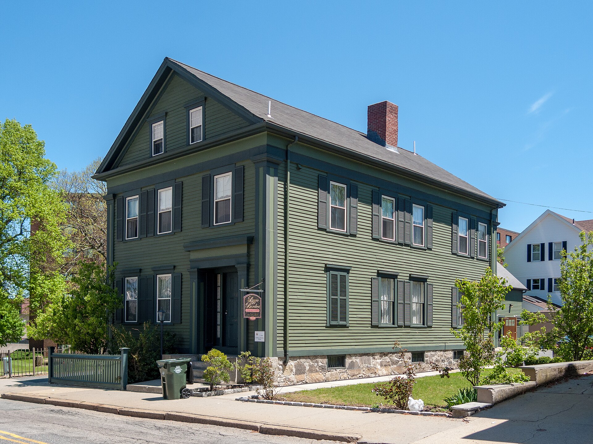 Green clapboard Lizzie Borden House in Fall River, photographed from across Second Street in 2017.